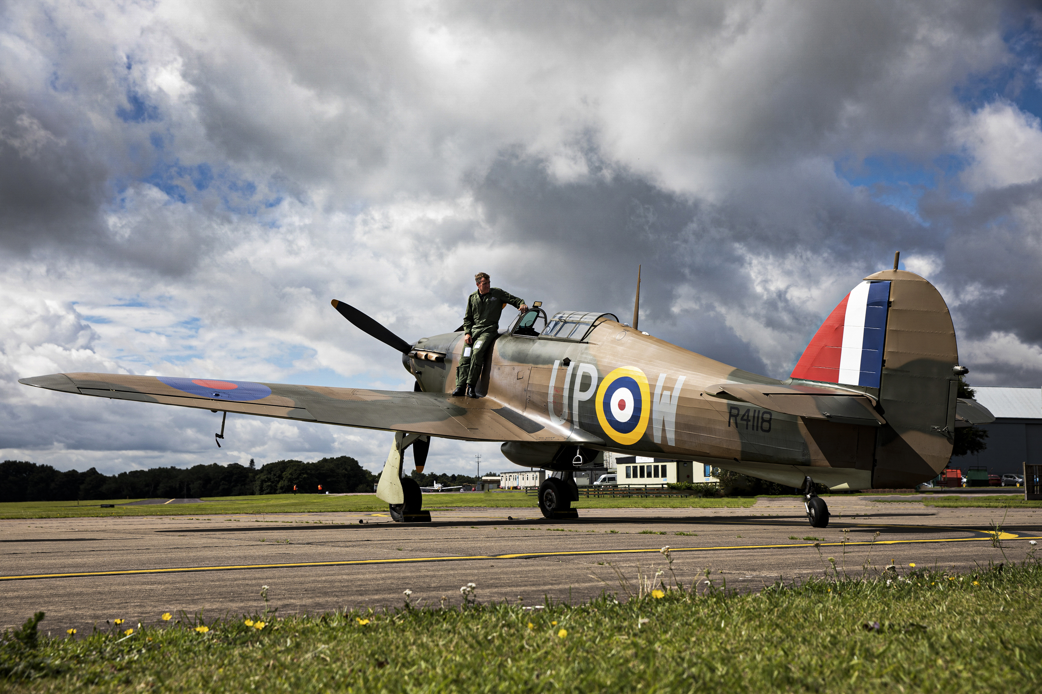World War II Hawker Hurricane R4118 and pilot on the airfield.
